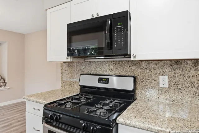 a kitchen with a stove and a microwave