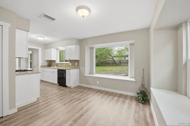 a kitchen with a refrigerator and a sink