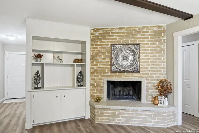 a stone house with fireplace and wooden floor