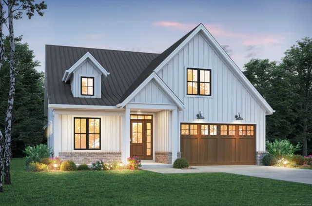 a front view of a house with a yard and outdoor seating