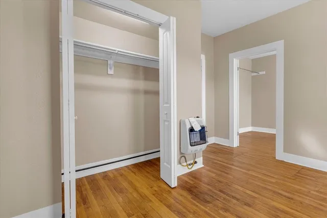 a view of a room with wooden floor