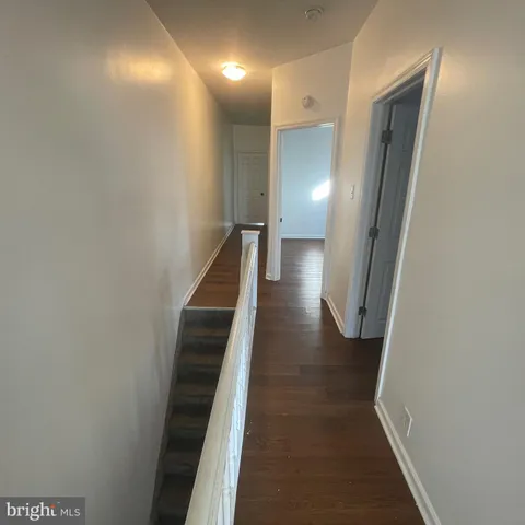 an empty room with a fan and a fan