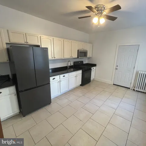 a kitchen with stainless steel appliances a refrigerator sink and cabinets
