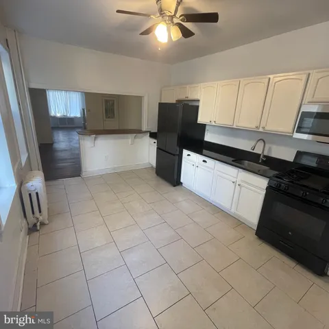 a kitchen with stainless steel appliances a sink stove and refrigerator