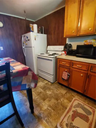 a kitchen with a refrigerator sink and cabinets