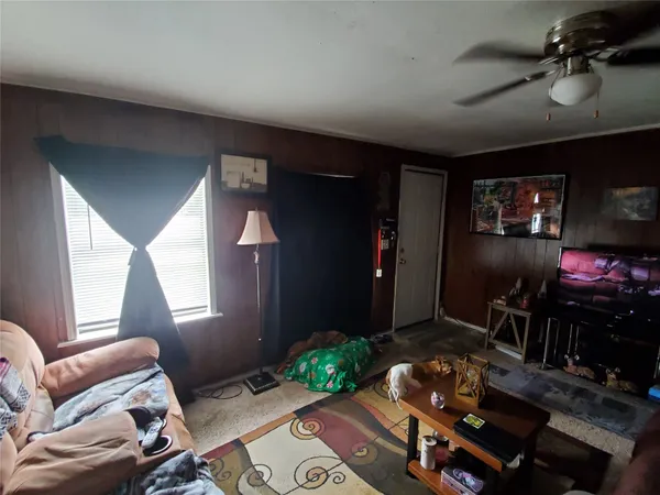 a bedroom with a bed and a ceiling fan
