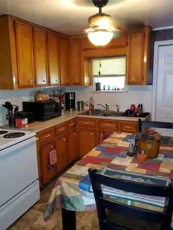a kitchen with a stove a sink and cabinets