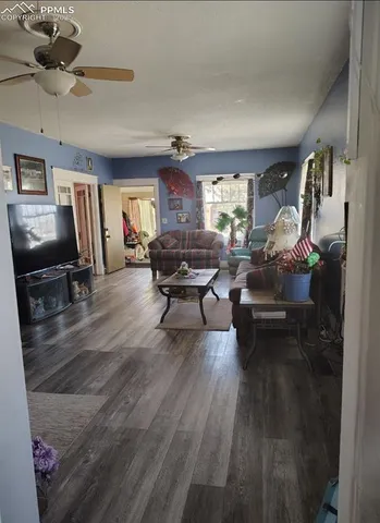 a living room with furniture and a wooden floor