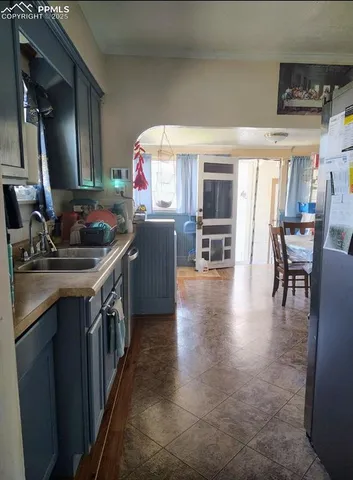 a kitchen with stainless steel appliances granite countertop a sink dishwasher stove and cabinets with wooden floor