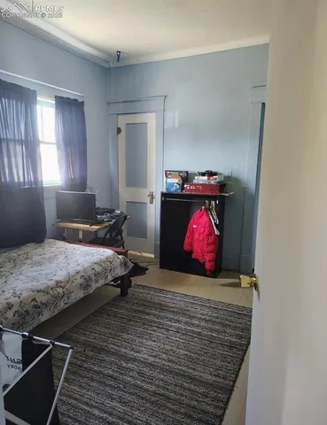 a bedroom with a bed and window