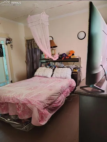 a bedroom with a bed and a chandelier