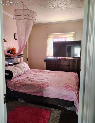 a bedroom with a bed and a mirror