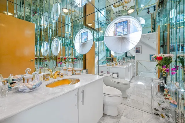 a bathroom with a toilet sink and shower