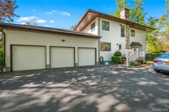 a front view of a house with a yard and potted plants