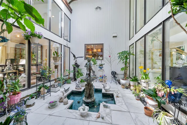 a living room with furniture potted plant and a fireplace