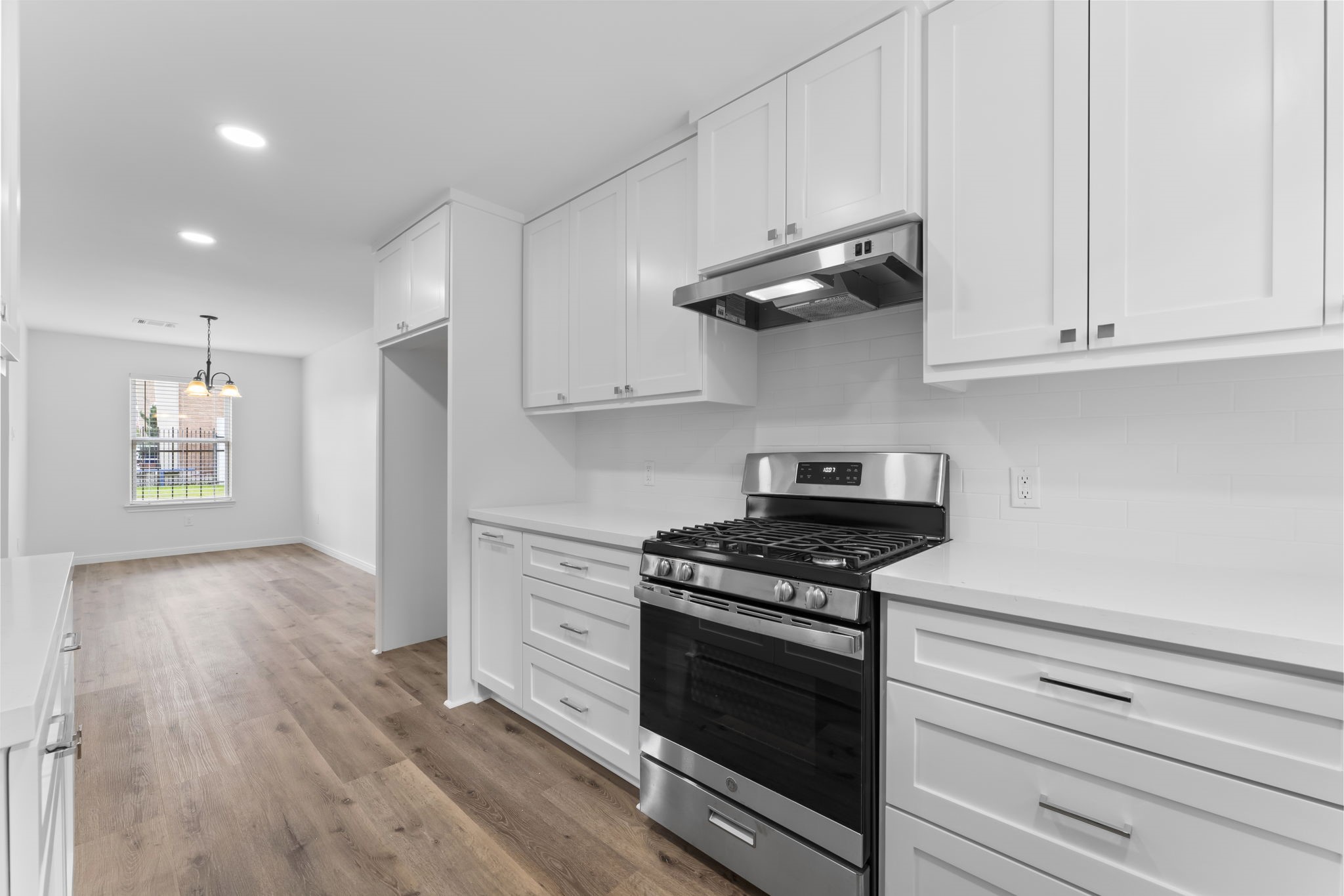 1507 North Durham Drive Houston, TX 77008 - Photo 15 of 35 a kitchen with stainless steel appliances granite countertop white cabinets and a stove top oven