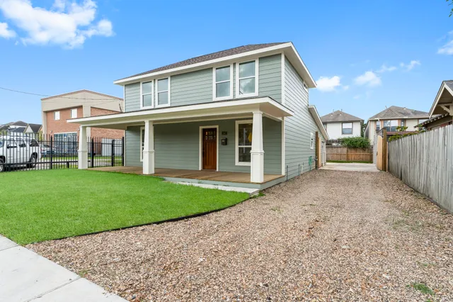 a view of a house with a yard and pathway
