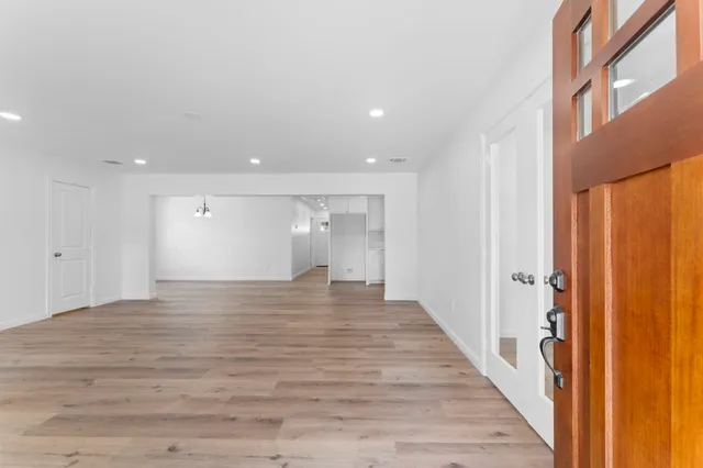 a view of a hallway with wooden floor