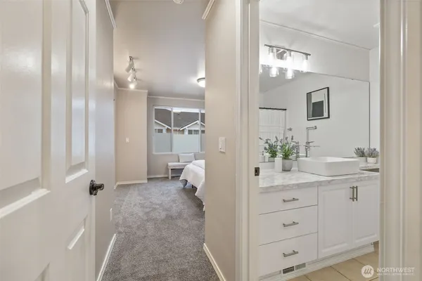 a spacious bathroom with a granite countertop sink a mirror and a shower