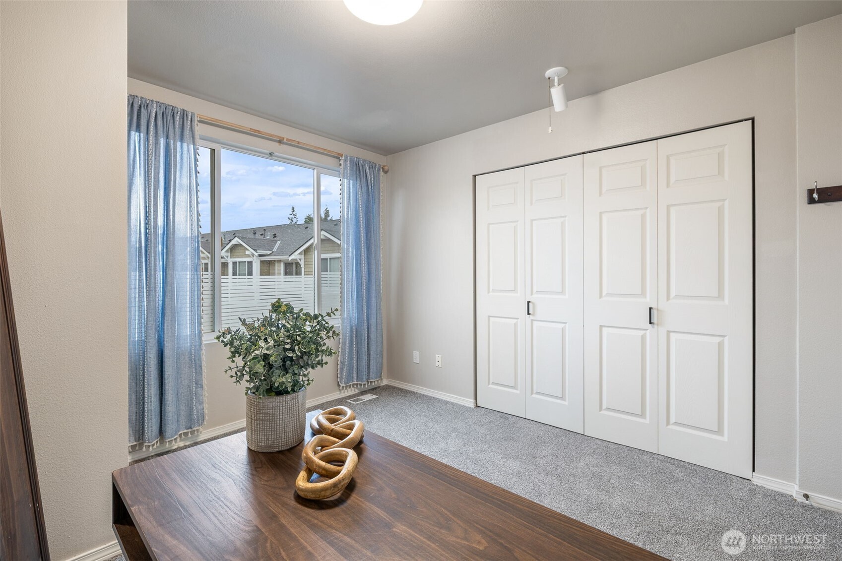 11895 Northeast 163rd Place, Unit 203 Bothell, WA 98011 - Photo 15 of 32 a room with chair and table with wooden floor
