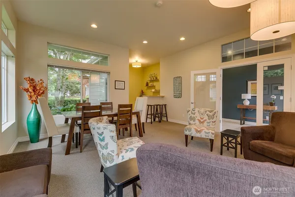 a living room with furniture a dining table and chairs