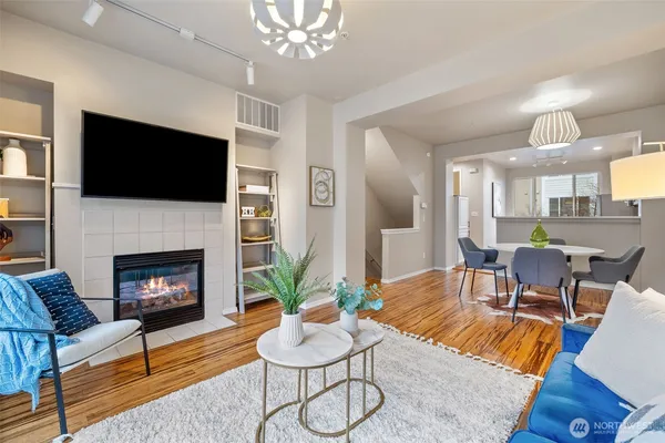 a living room with furniture a flat screen tv and a fireplace