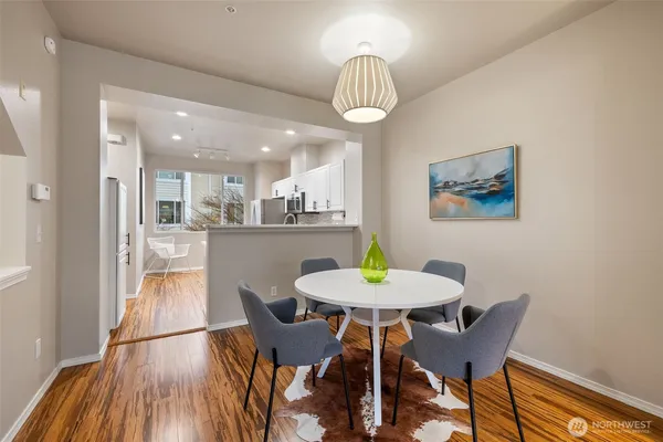 a view of a dining room with furniture and wooden floor