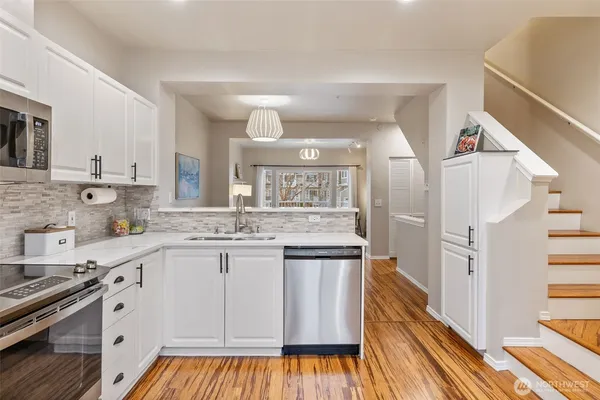 a kitchen with a stove a sink and a refrigerator