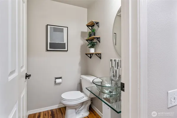 a bathroom with a sink toilet and a mirror