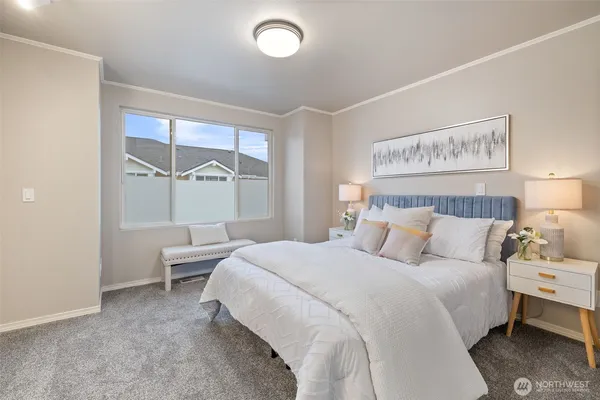 a bedroom with a bed and a large window