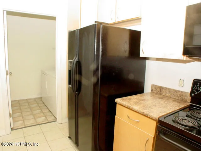 a kitchen with a refrigerator and a stove