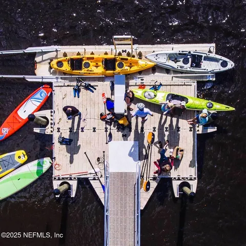 a living room with furniture a flat screen tv and a large window