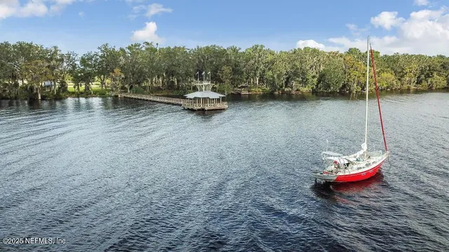 a view of a house with swimming pool and sitting area