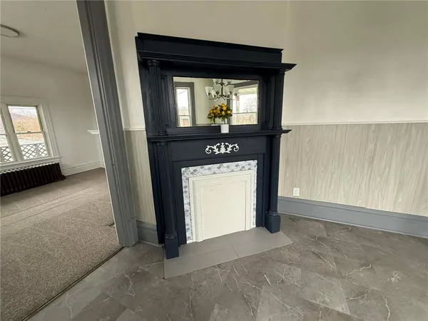 a view of a livingroom with an empty space and a window