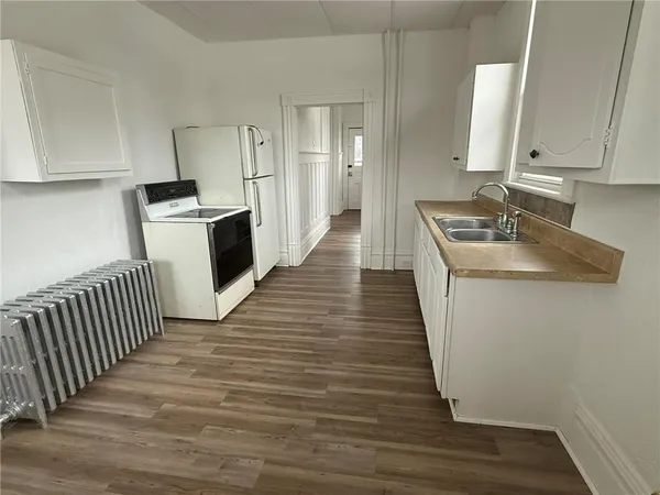 an empty room with furniture and windows