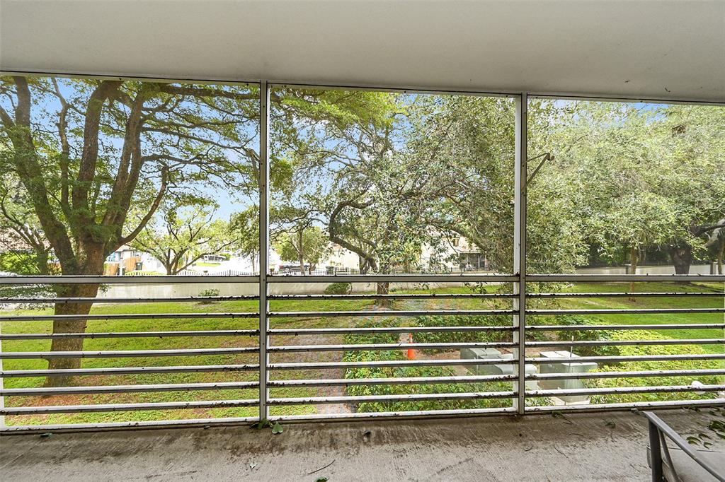 a green field with trees in the background