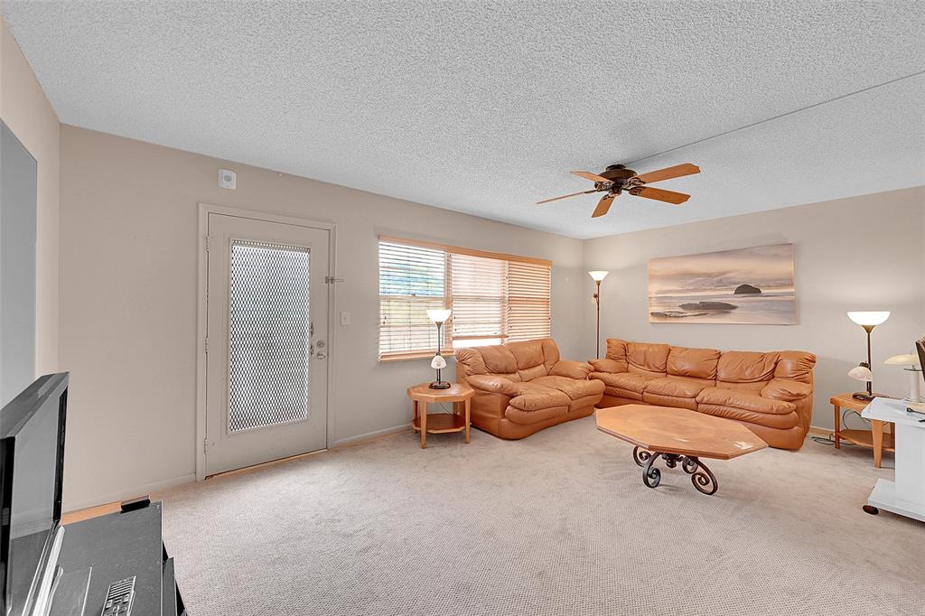 1901 Bermuda Circle, Unit F2 Coconut Creek, FL 33066 - Photo 11 of 26 a living room with furniture and a window