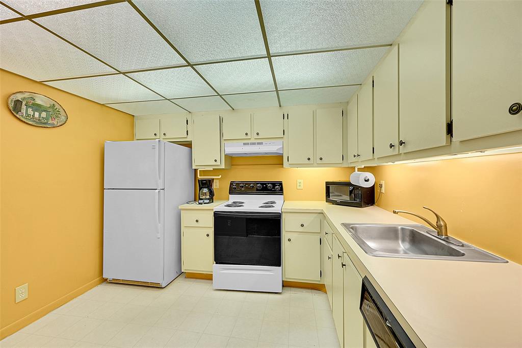 1901 Bermuda Circle, Unit F2 Coconut Creek, FL 33066 - Photo 14 of 26 a kitchen with a refrigerator sink stove and cabinets