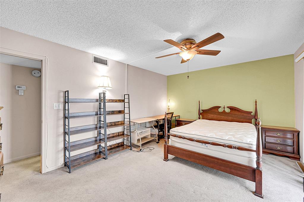 1901 Bermuda Circle, Unit F2 Coconut Creek, FL 33066 - Photo 15 of 26 a bedroom with a bed and a ceiling fan