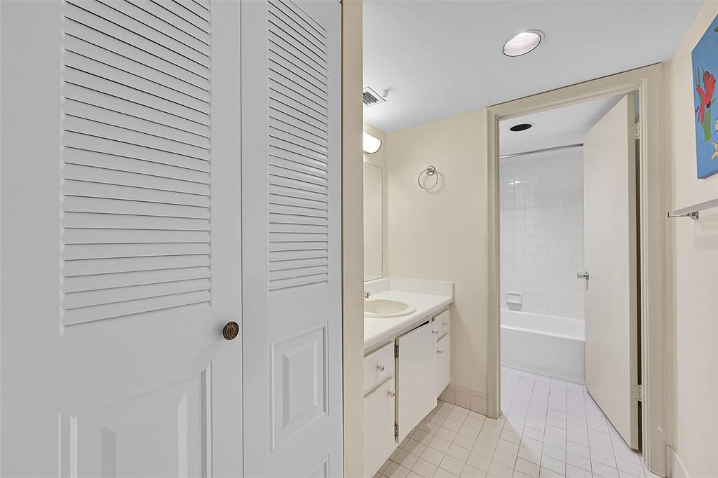 1901 Bermuda Circle, Unit F2 Coconut Creek, FL 33066 - Photo 17 of 26 a bathroom with a sink a mirror and a shower
