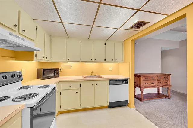 a view of a kitchen with electric appliances