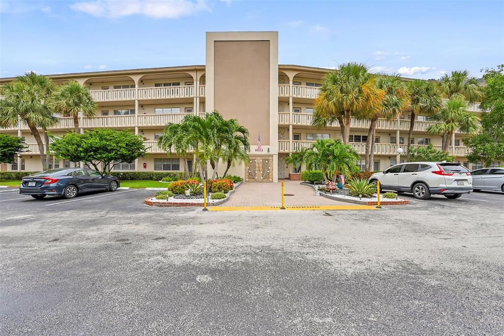 1901 Bermuda Circle, Unit F2 Coconut Creek, FL 33066 - Photo 25 of 26 a view of a street with cars parked
