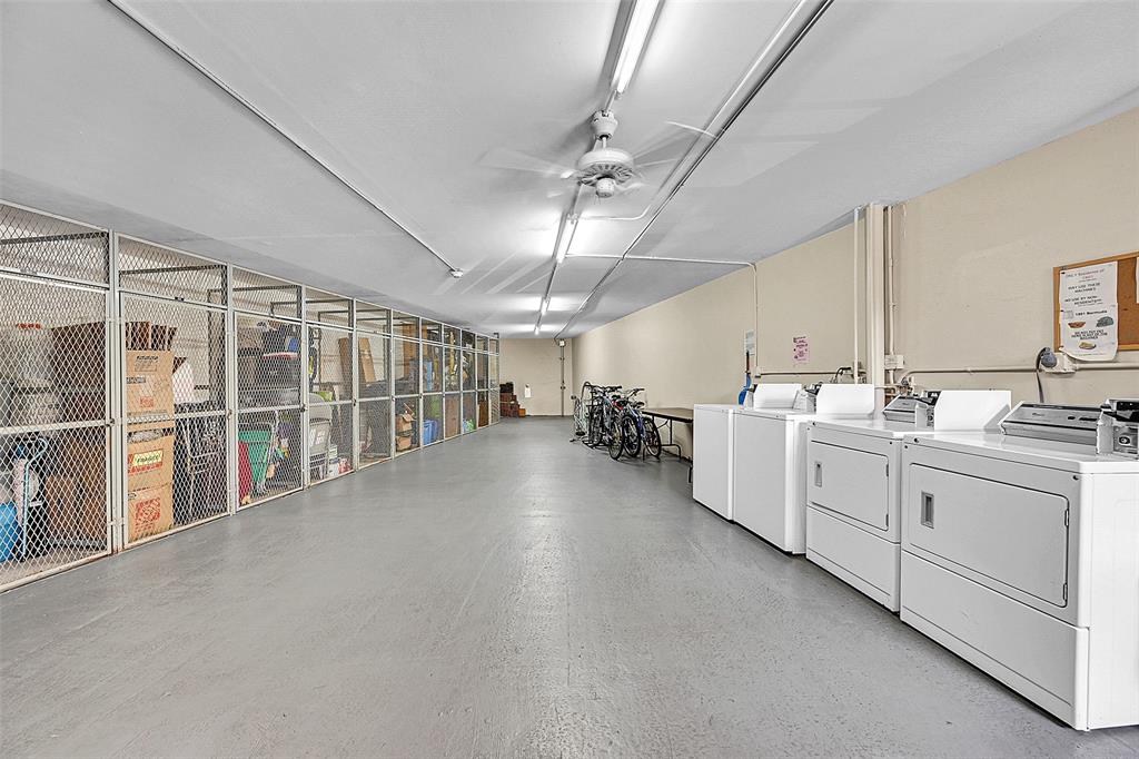 1901 Bermuda Circle, Unit F2 Coconut Creek, FL 33066 - Photo 8 of 26 a large white kitchen with cabinets a sink a window and stainless steel appliances