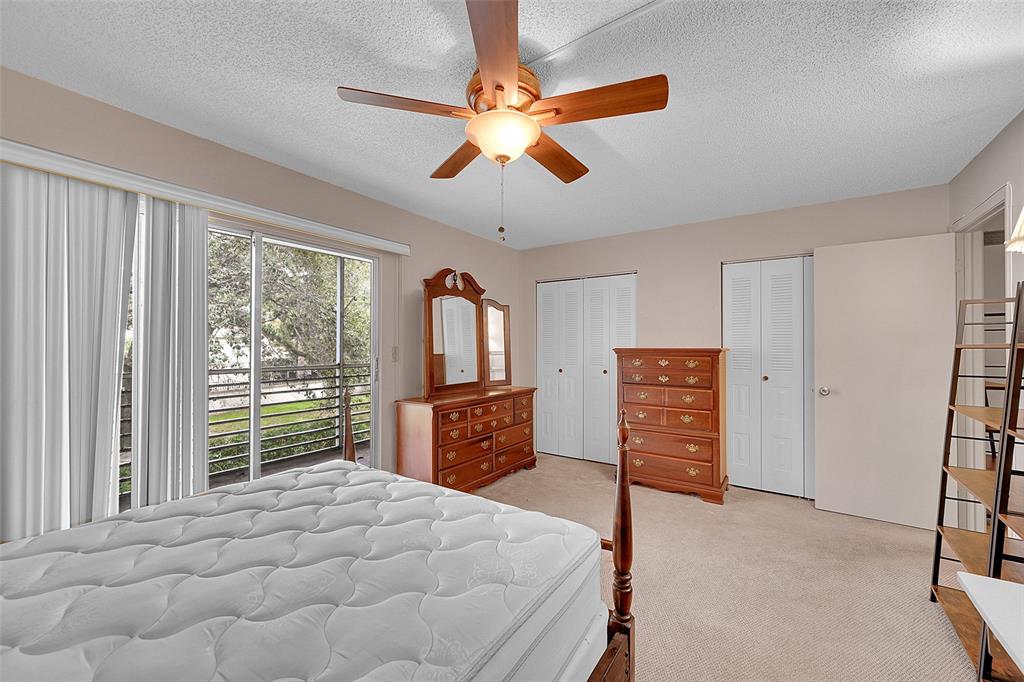1901 Bermuda Circle, Unit F2 Coconut Creek, FL 33066 - Photo 9 of 26 a bedroom with a bed and a large window