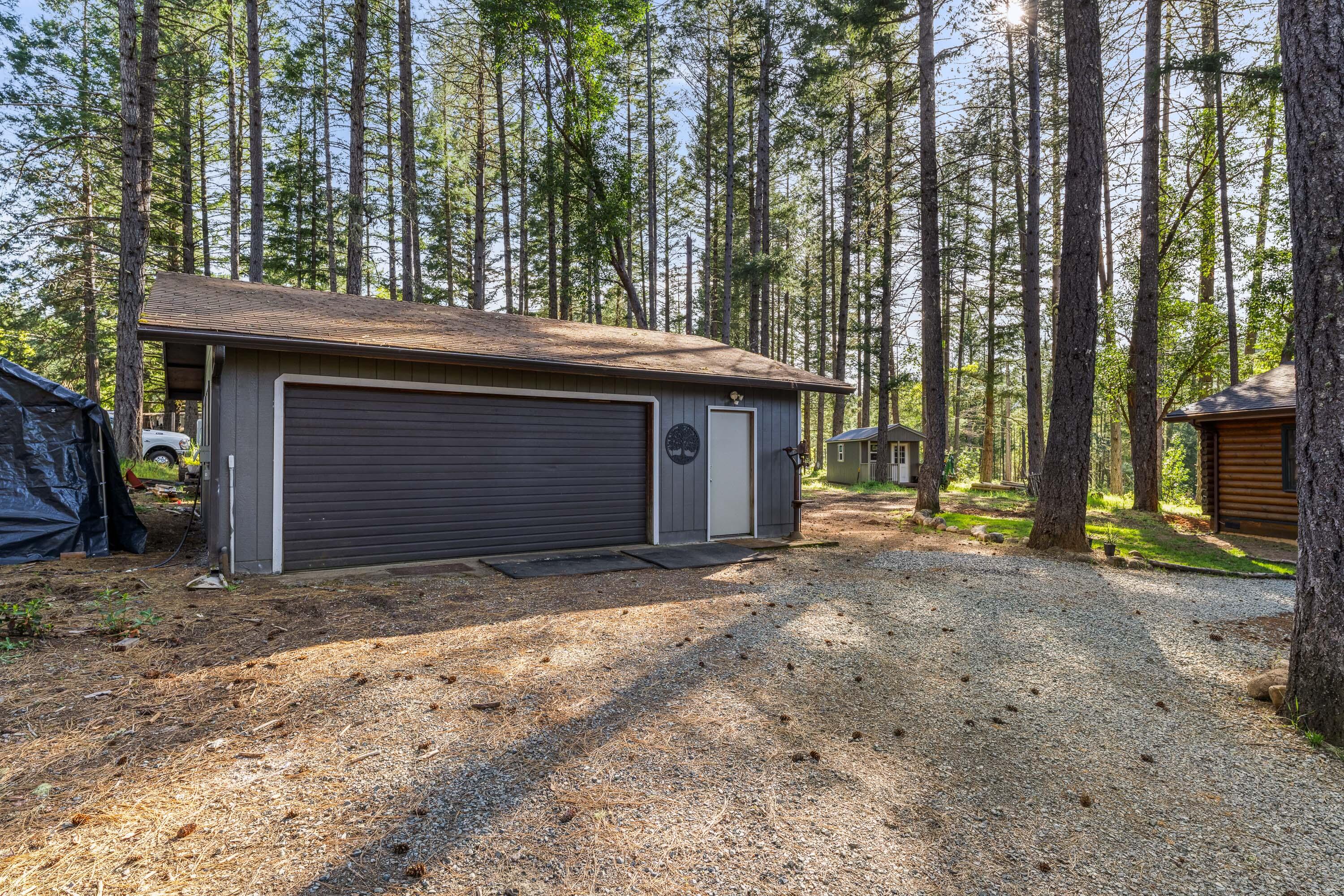 1201 Reeves Creek Road Selma, OR 97538 - Photo 24 of 38 a view of a house with a tree and wooden fence