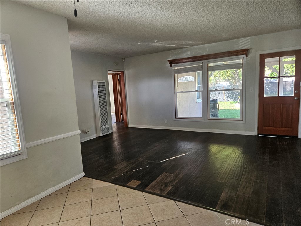 14679 Nurmi Street Sylmar, CA 91342 - Photo 5 of 5 an empty room with wooden floor and windows