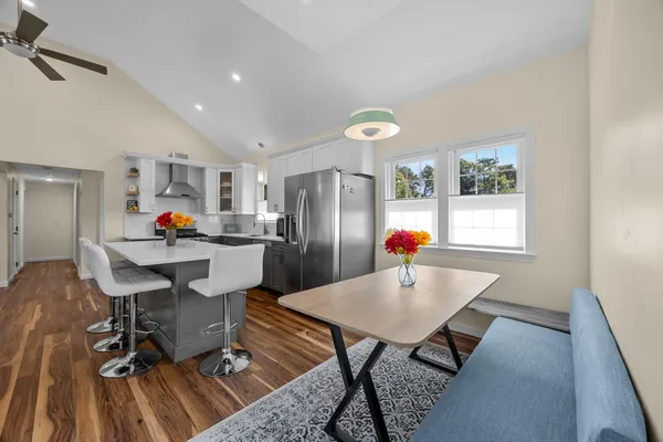 a living room with dining room and wooden floor