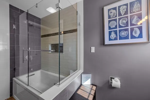 a bathroom with a bathtub and shower