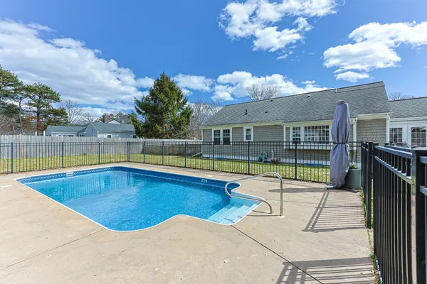a view of a house with swimming pool and sitting area