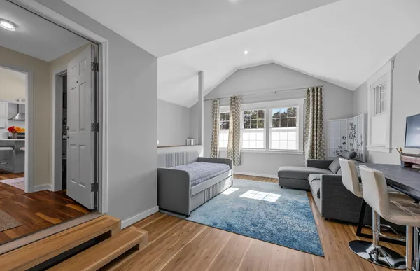 a living room with furniture rug and window